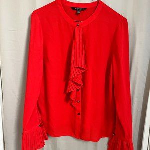 Eva Longoria Red button-up blouse with ruffled cuffs and a jabot.